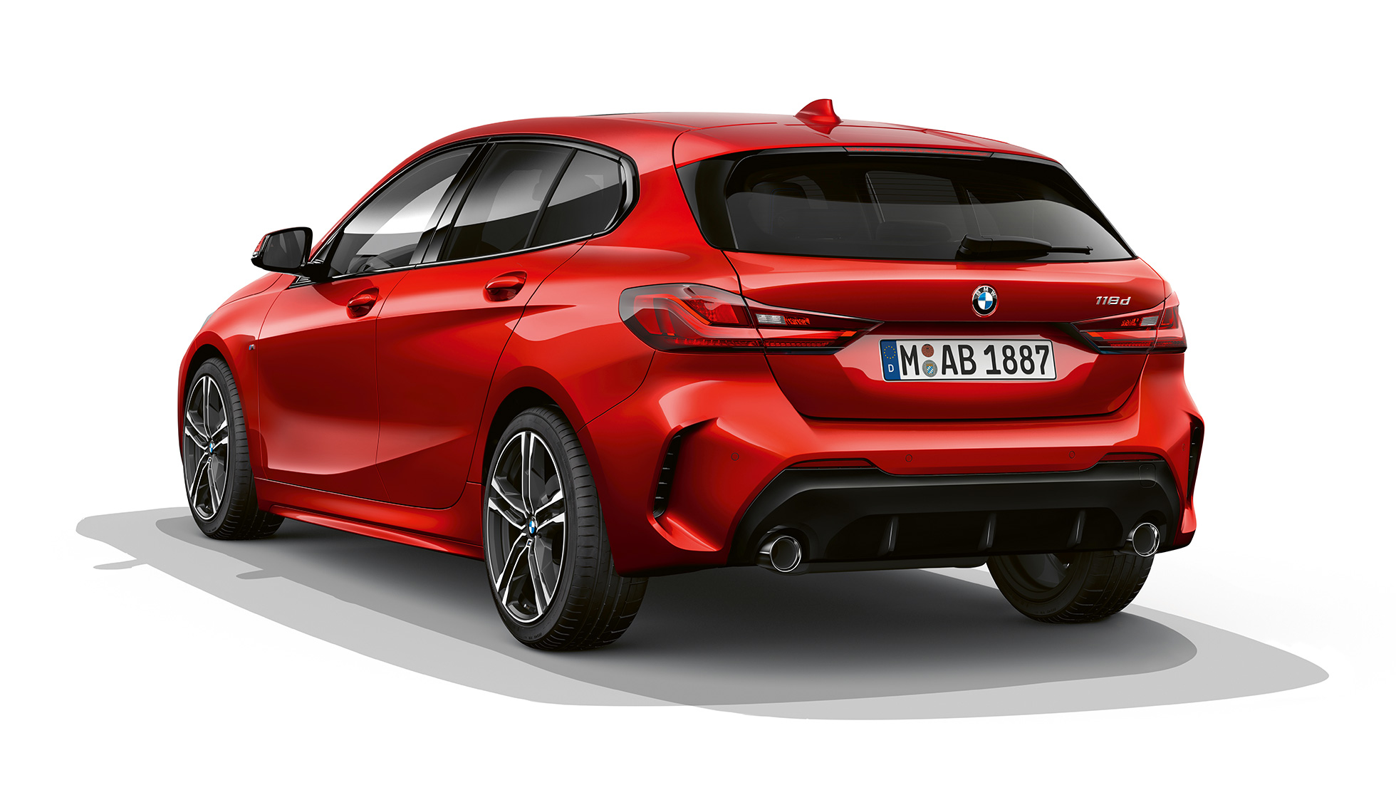 BMW 1 Series Model M Sport, three-quarter rear. BMW 1 Series Model M Sport in Melbourne Red metallic, studio shot three-quarter rear.