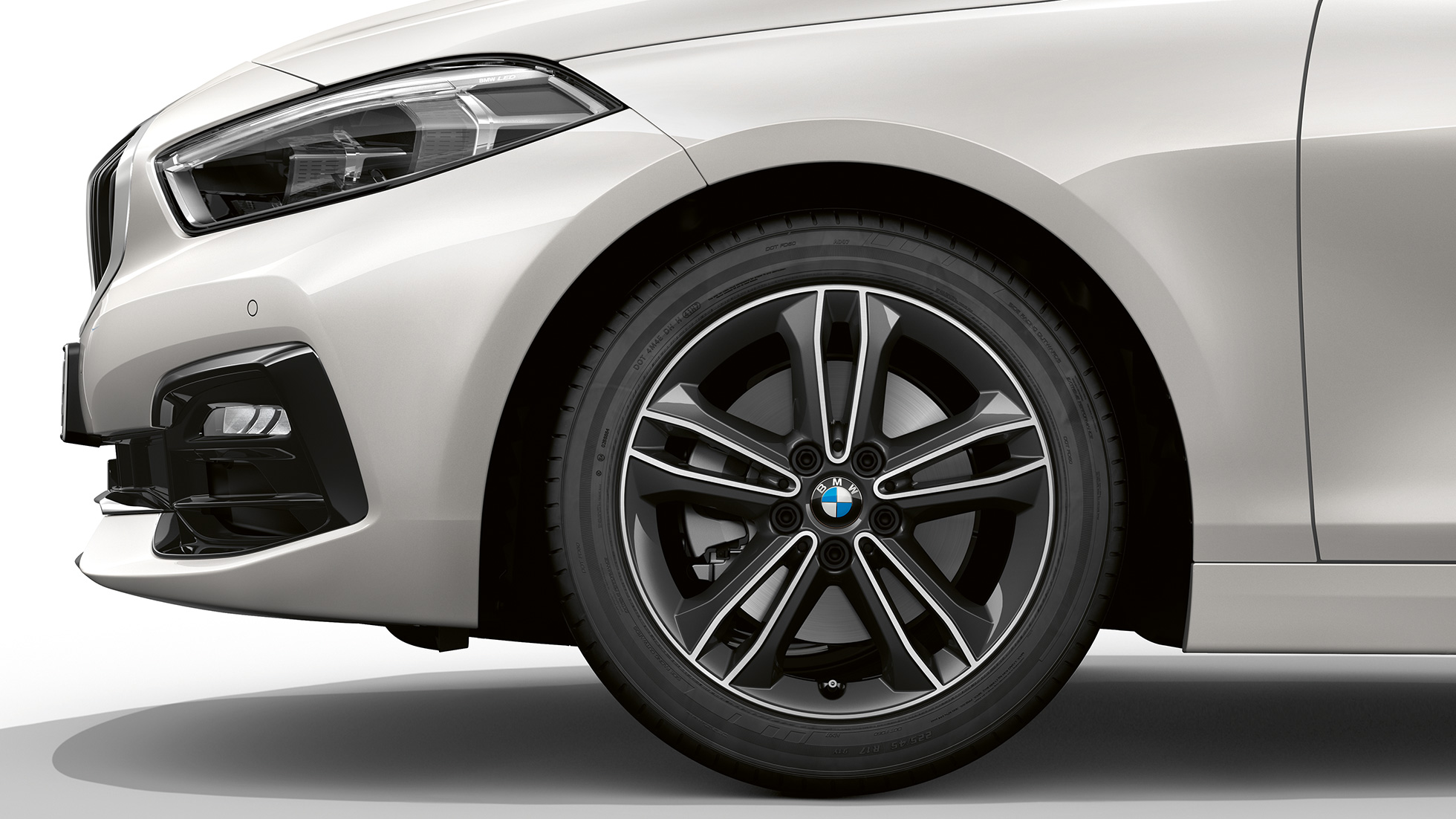 17" light-alloy wheel Double-spoke 549 style. BMW 1 Series Model Sport Line in Mineral White metallic, side view of front with 17'' light-alloy wheel Double-spoke 549 style.