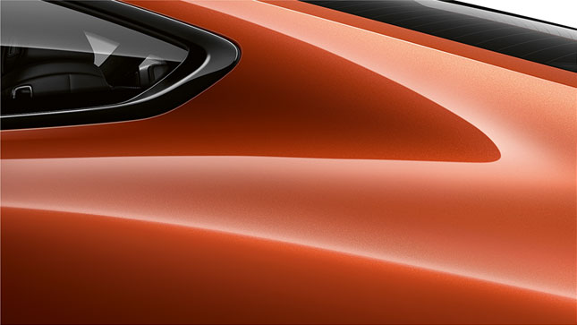 Close-up of the C pillar of the BMW 8 Series Coupé in Sunset Orange metallic.