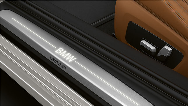 Close-up of the door sill of the BMW 8 Series Coupé with BMW logo.
