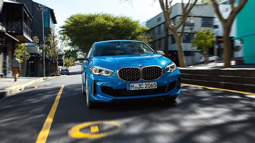 BMW 1 Series in Misano Blue metallic, front view driving.