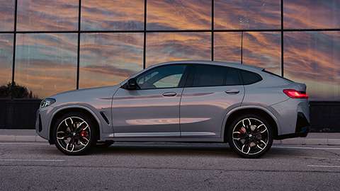 BMW X Series BMW X4 G02 three-quarter rear view driving on the street 