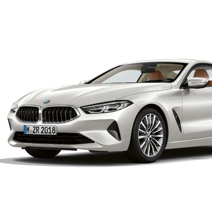 BMW 8 Series Coupé, Mineral White metallic, three-quarter front view.